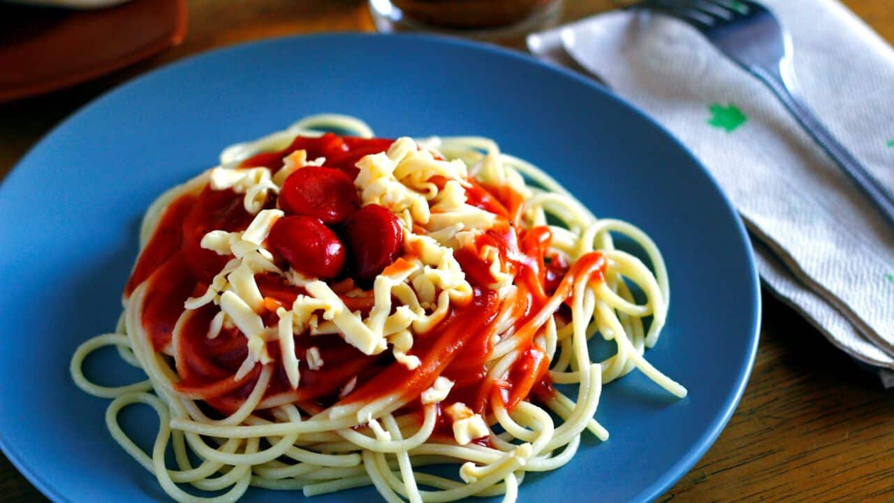 Bright red, sweet Filipino spaghetti with hotdogs.