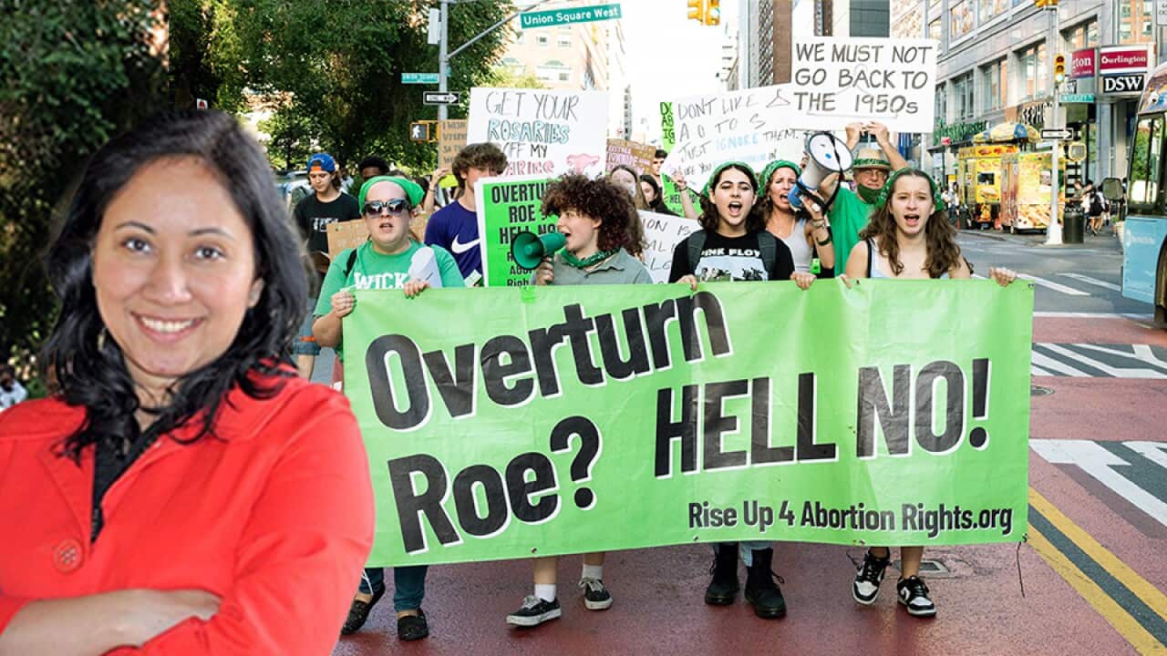 People holding a banner saying "Overturn Roe? Hell no!" and a various signs at a rally and march for abortion rights. (Photo by Michael Brochstein/Sipa USA)