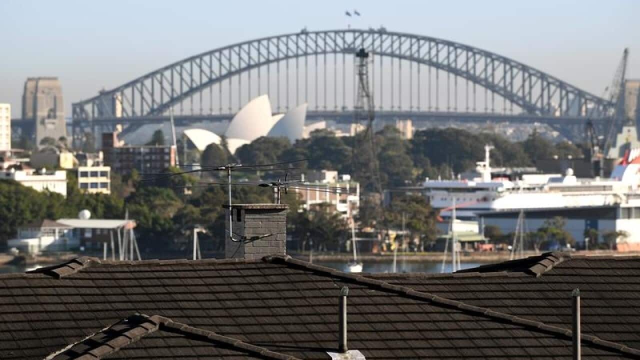 The Sydney Harbour Bridge is seen behindhousing in Sydney's east.