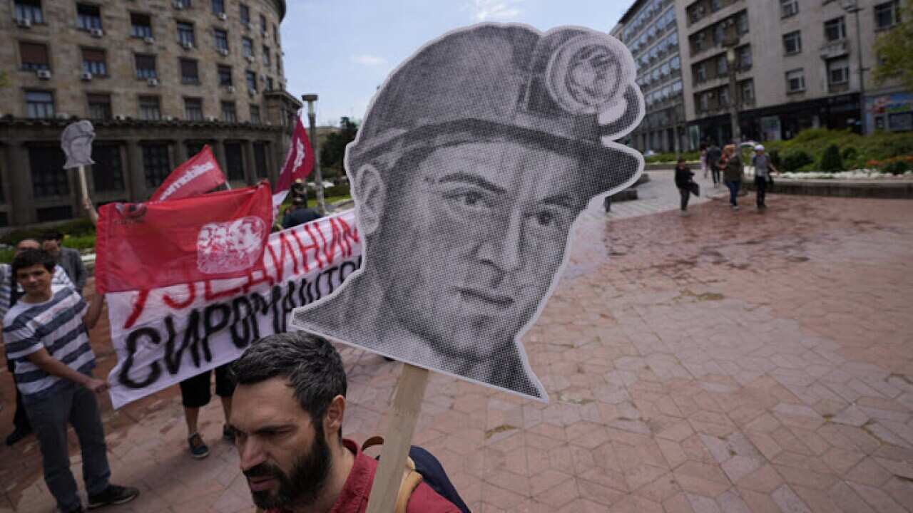 People attend a May Day rally on International Workers Day in Belgrade, Serbia, Sunday, May 1, 2022. Workers and activists marked May Day with defiant rallies and marches for better pay and working conditions. (AP Photo/Darko Vojinovic)