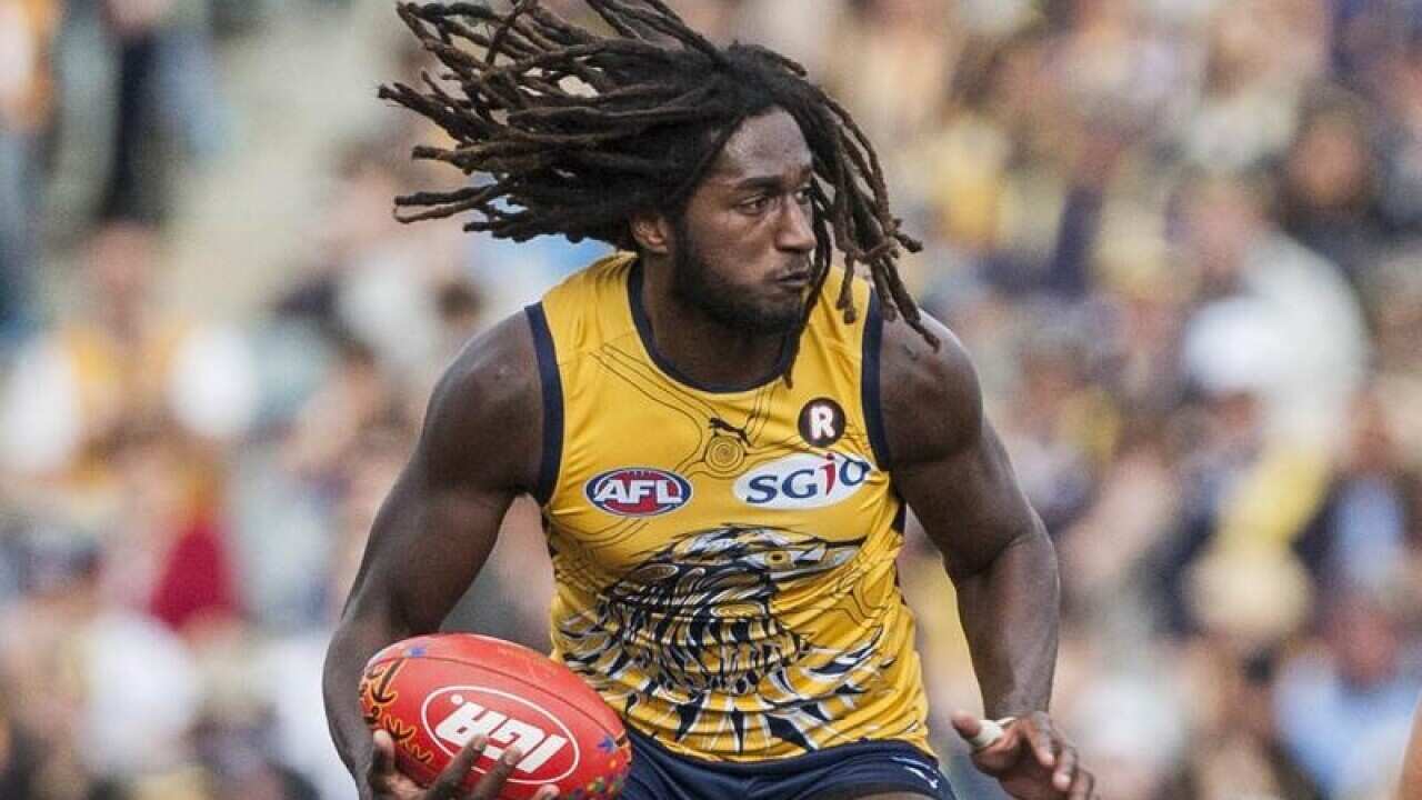 Nic Naitanui holds the ball.