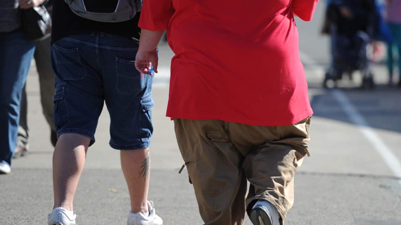 An overweight man walks