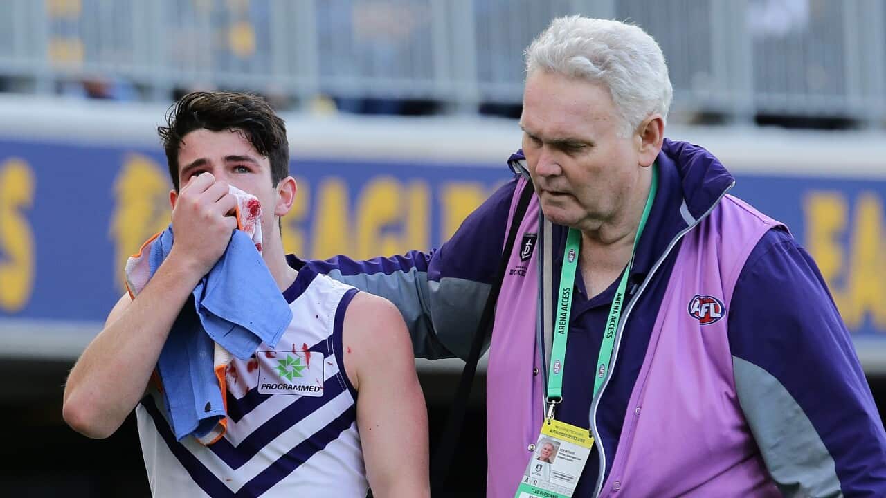 Andrew Brayshaw of the Dockers leaves the field with a broken jaw from contact with Andrew Gaff during the AFL match between West Coast Eagles and Fremantle