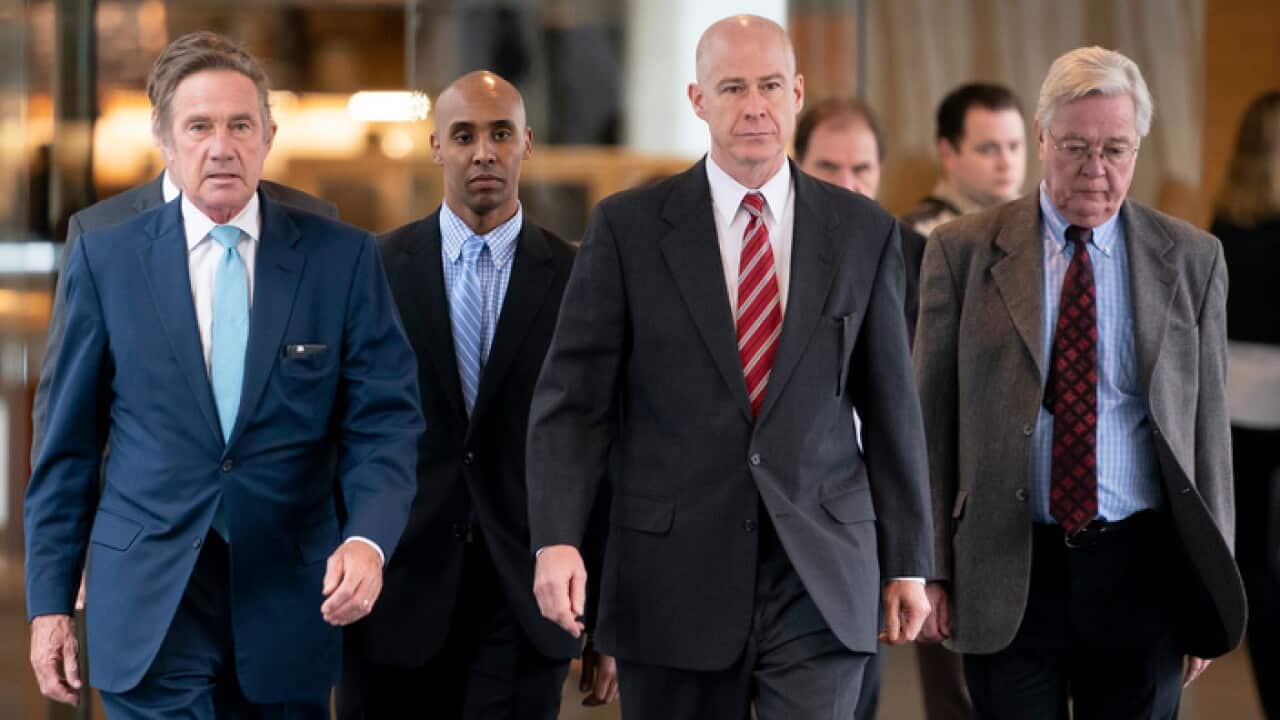 Former Minneapolis police officer Mohamed Noor walks with his lawyers into Court for the verdict in the shooting death of Justine Ruszczyk Damond