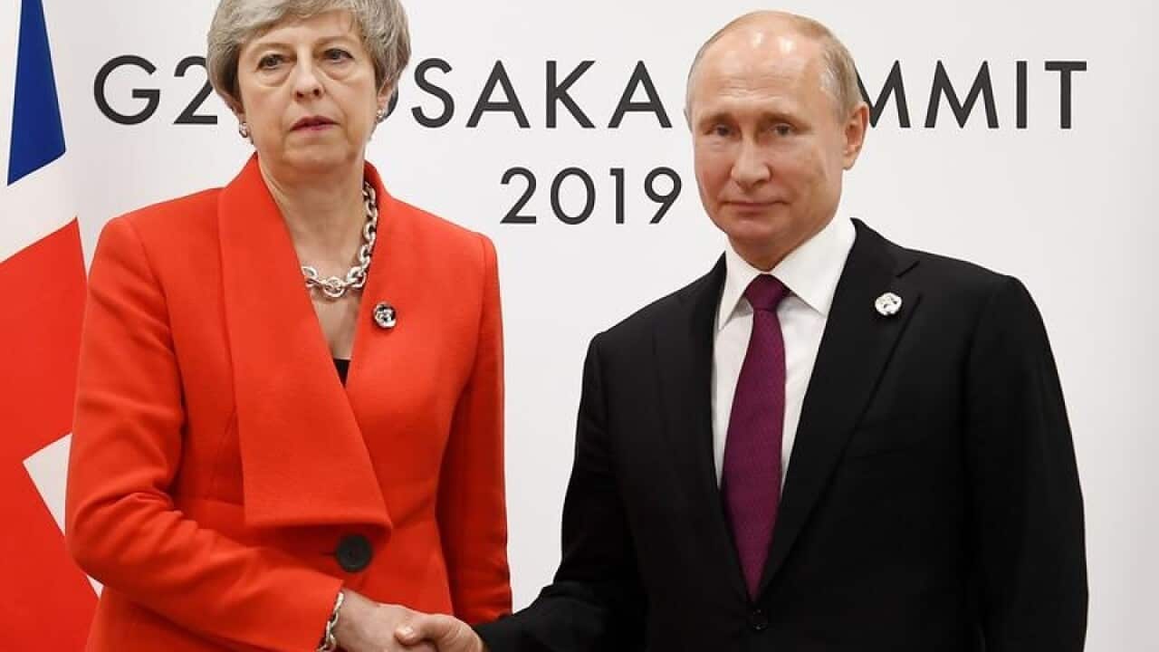 British PM Theresa May (L) and Russian President Vladimir Putin