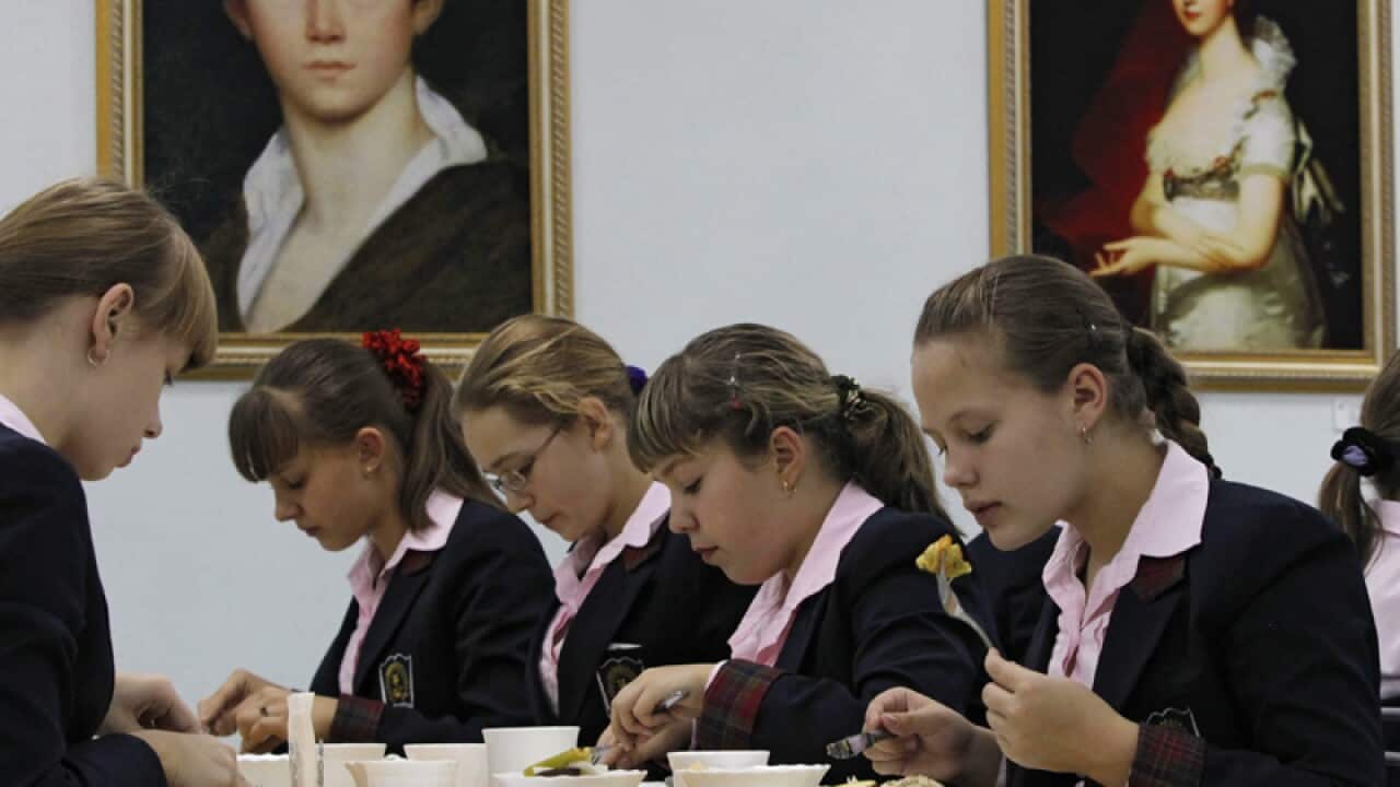 Girls have dinner at a Russian boarding school for girls