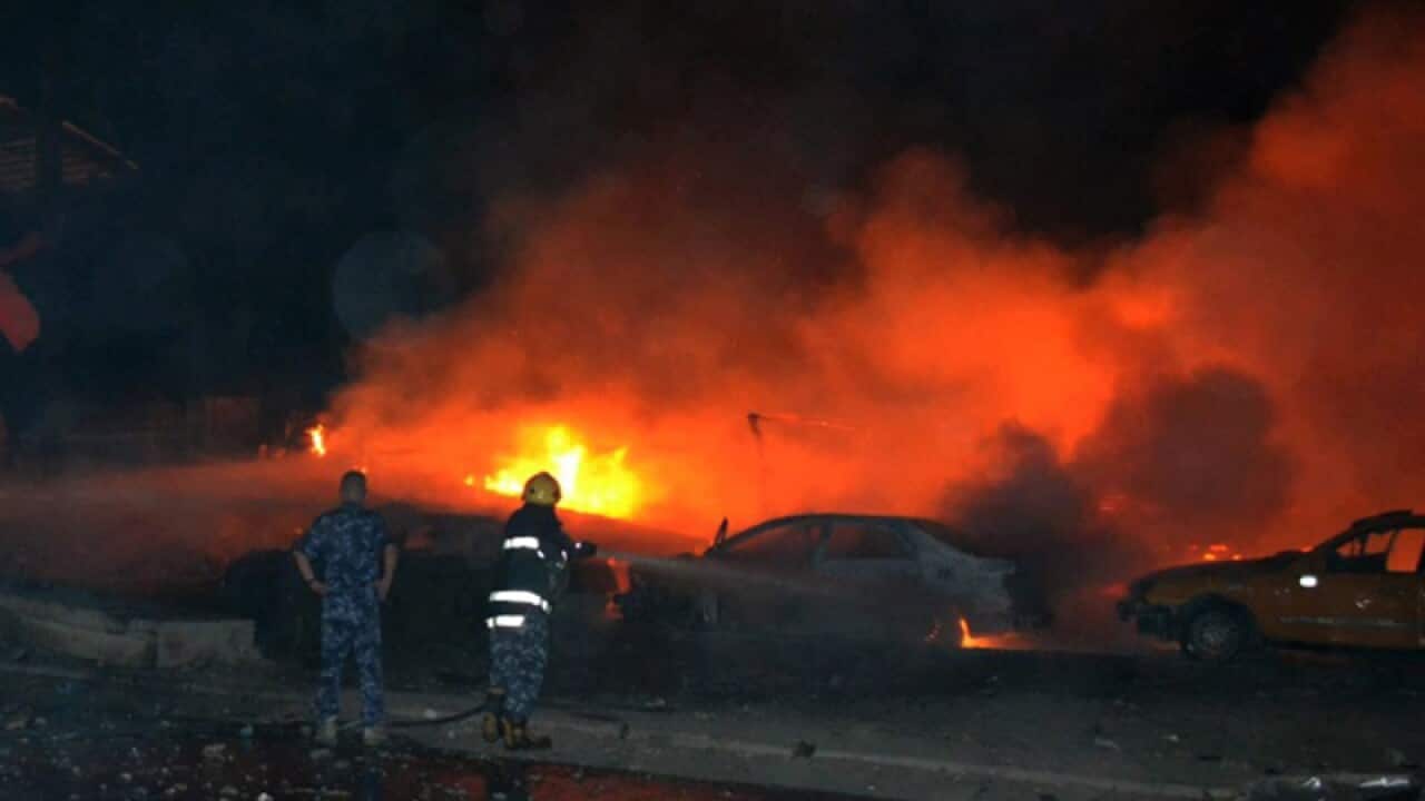 Iraqi firefighters at the scene of a car bomb attack in Kirkuk city
