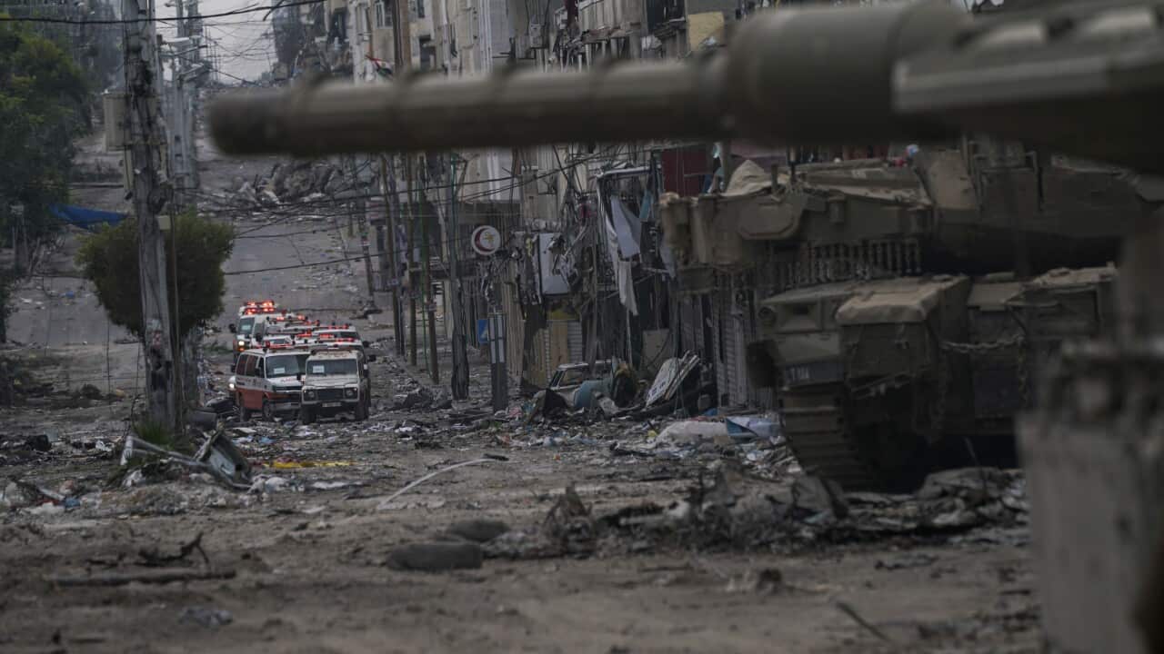 Ambulances near an Israeli forces tank in the Gaza Strip.