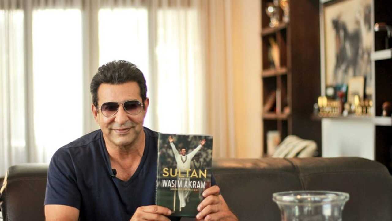Wasim Akram, with his memoir written by Gideon Haigh (Credit Wasim Akram Facebook)