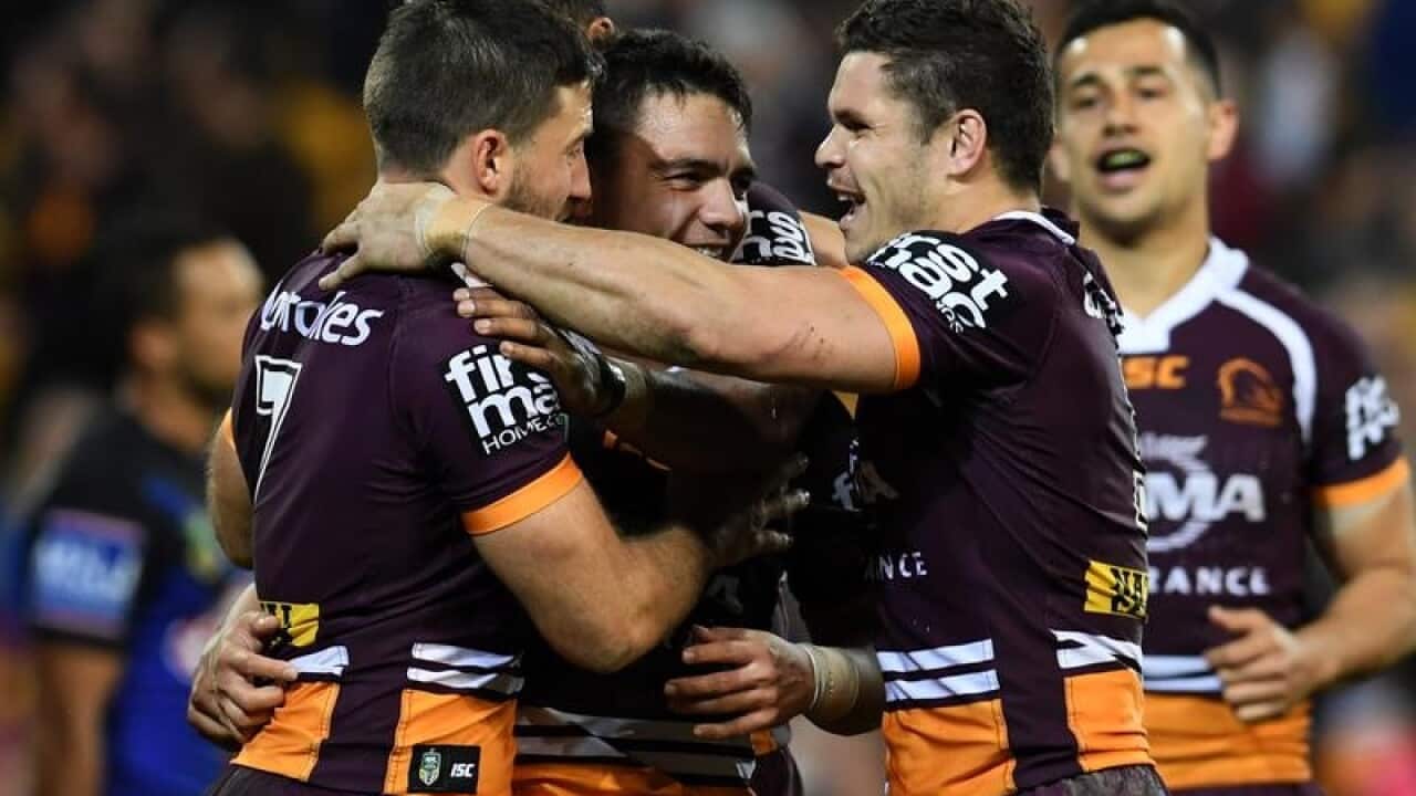 Kodi Nikorima of the Broncos (C) celebrates scoring a try