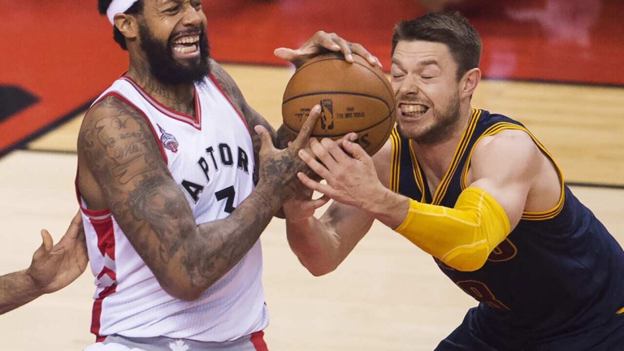 Toronto's James Johnson and Cleveland's Matthew Dellavedova