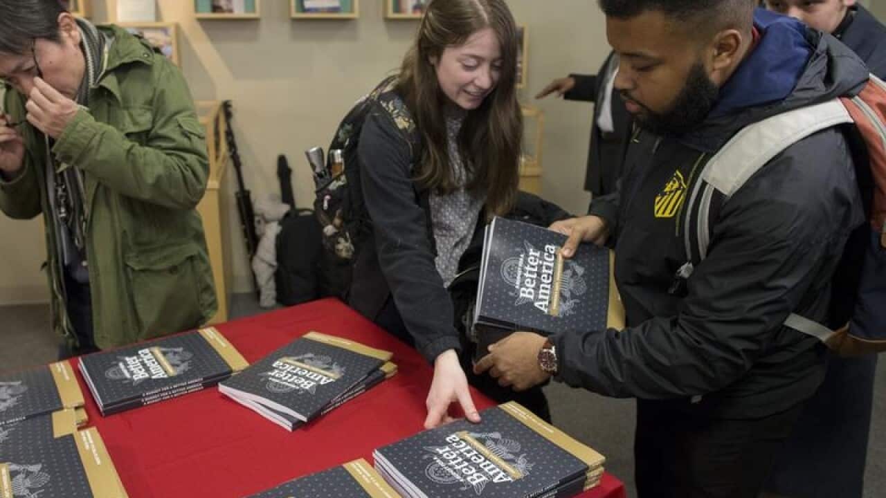 Members of the public pick up copies of President Trump's budget