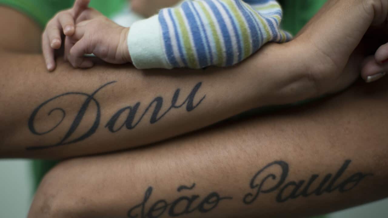 Tatiana Ribeiro holds her newborn