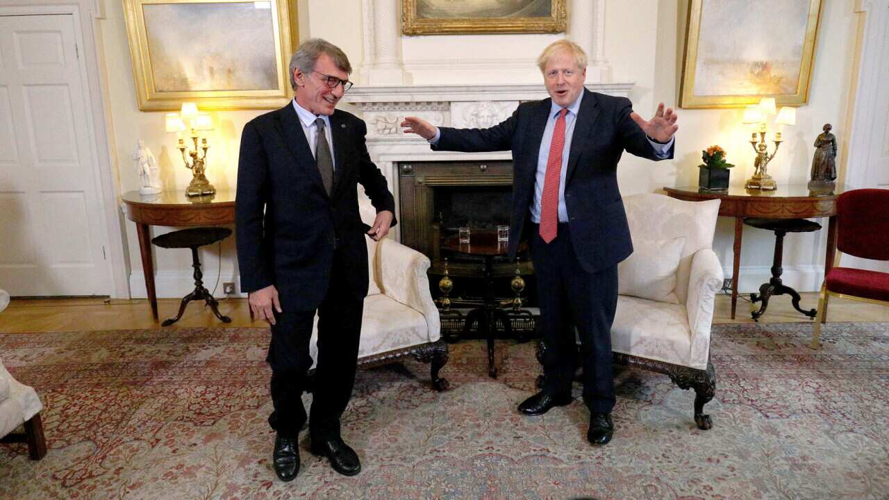 Boris Johnson gestures as he stands with the President of the European Parliament David Sassoli