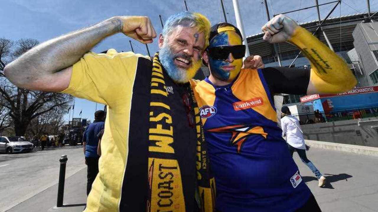 West Coast Eagles supporters pose for a photo ahead of the AFL Grand Final at the MCG in Melbourne