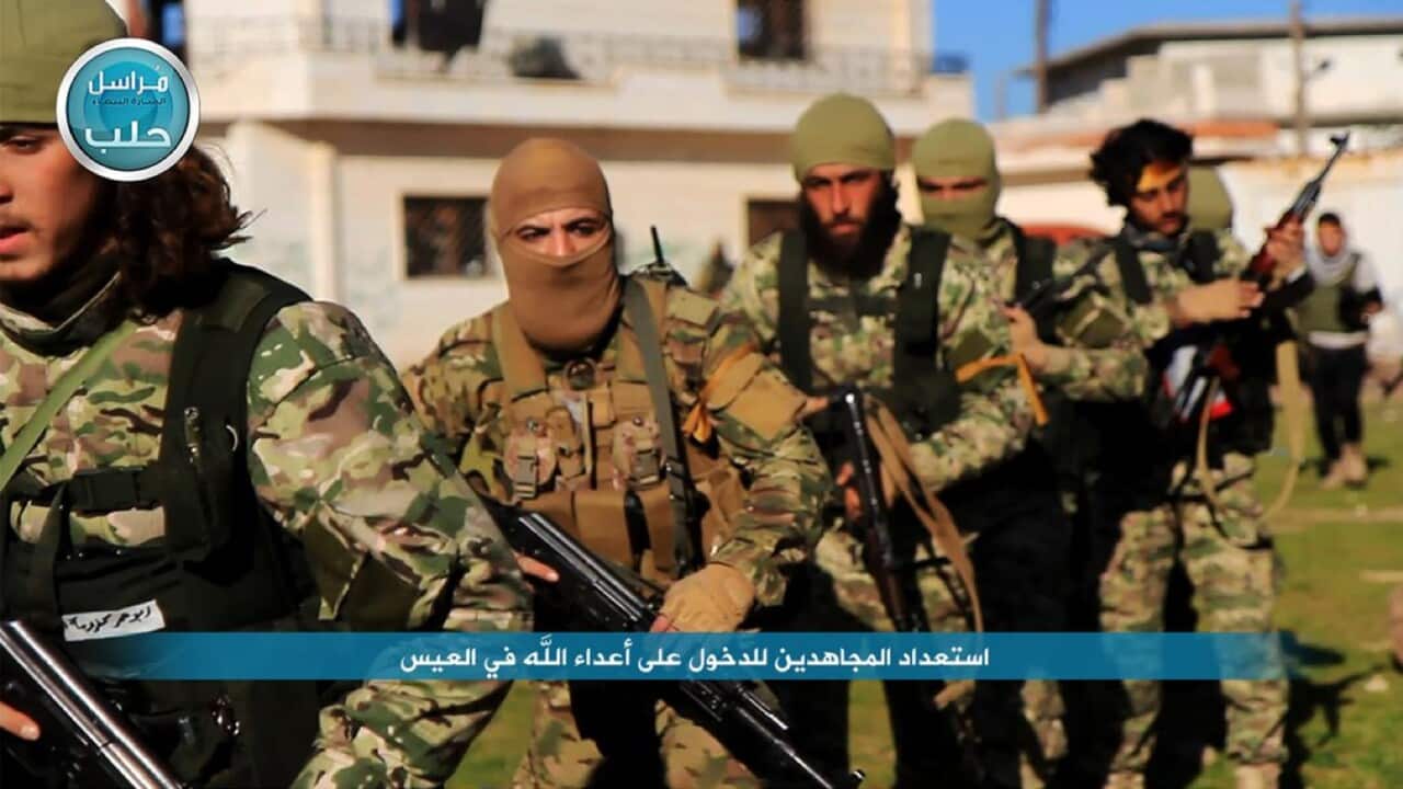 File photo of fighters from al-Qaida's branch in Syria, the Nusra Front, marching toward the northern village of al-Ais in Aleppo province, Syria.
