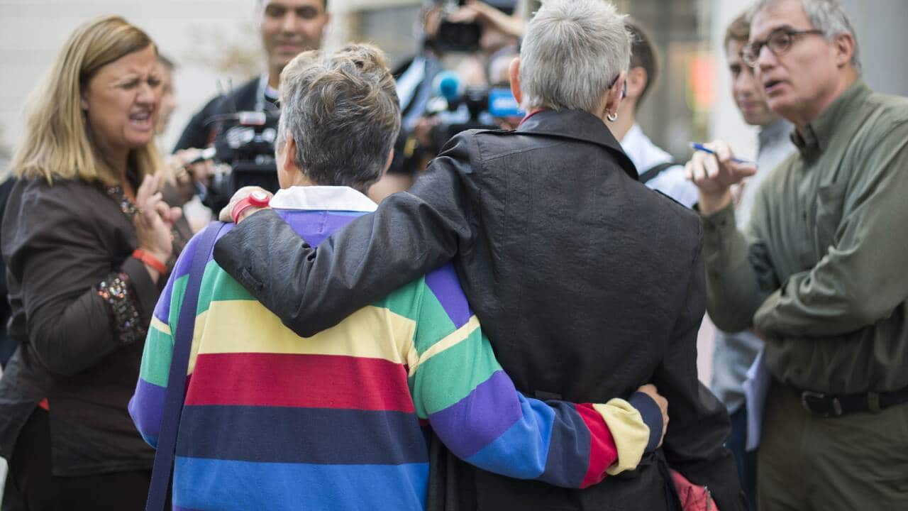 Rhonda Buckner (L) and Diane Ullius (R), who got a same-sex marriage in Toronto, Canada, talk with reporters after Virginia Attorney General Mark R. Herring announced that couples can begin to marry immediately in Arlington, Virginia, October 6, 2014. (AA