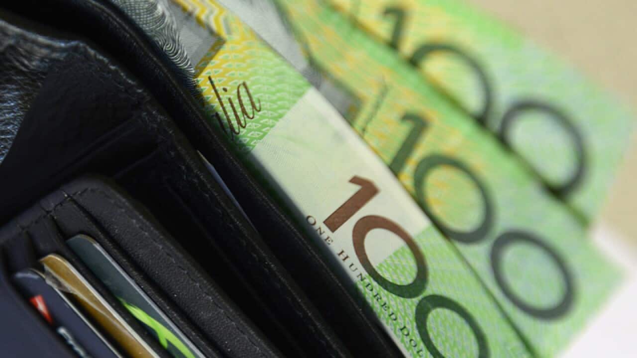 $100 Australian dollar notes pop out of a wallet