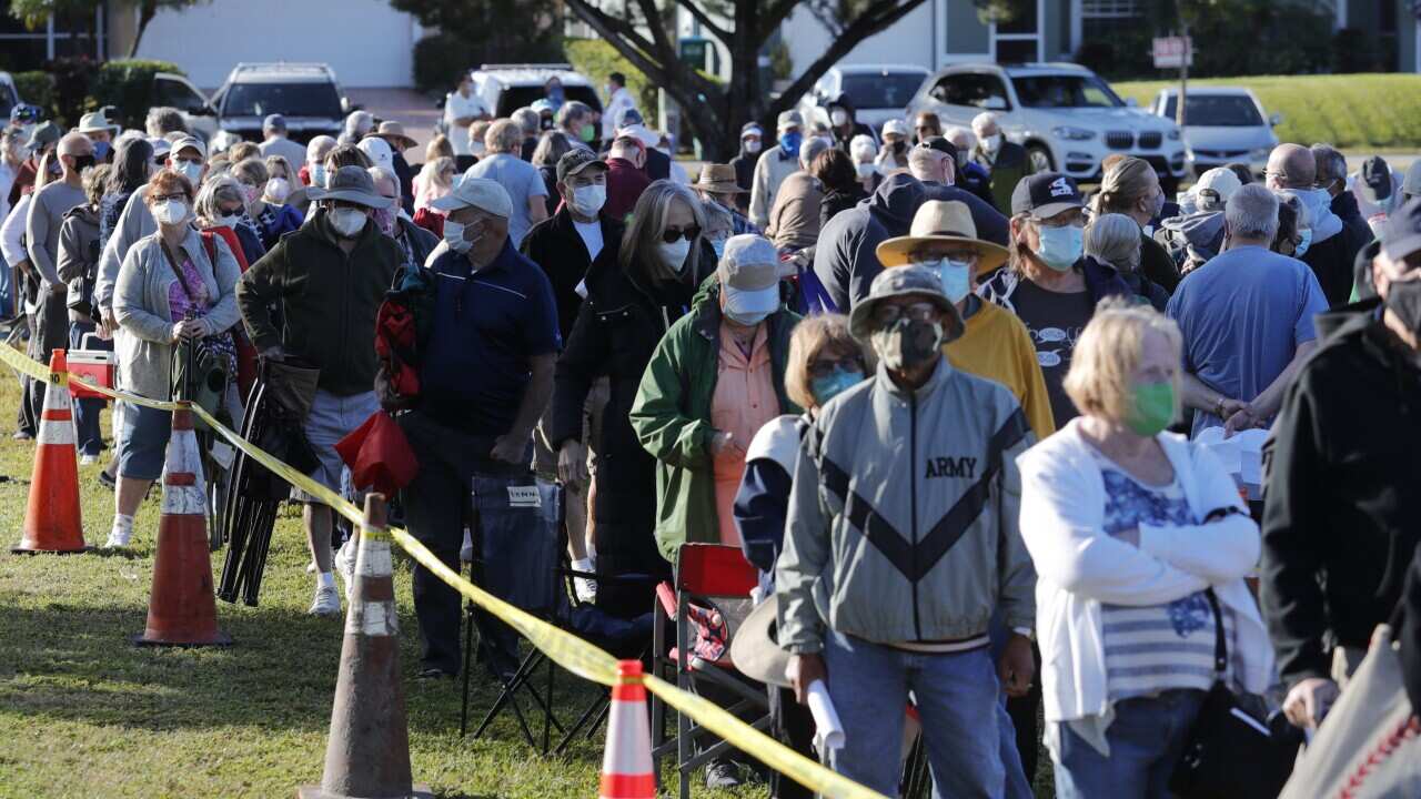 Residents of Florida's Cape Coral wait in line to receive a COVID-19 vaccine 30 December, 2020.