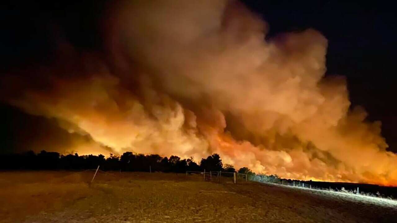 A fast-moving bushfire continues to rage north of Perth threatening lives and homes.