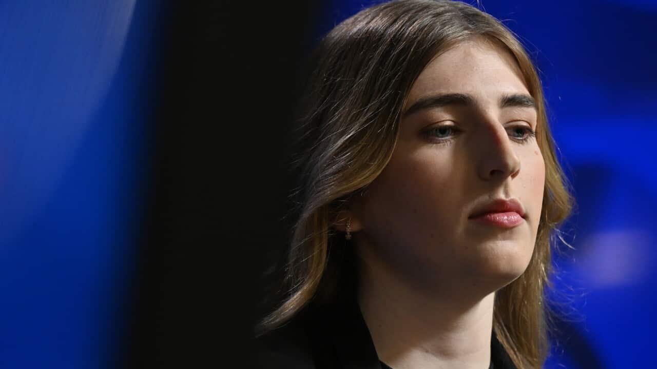 Woman stares out from the camera.