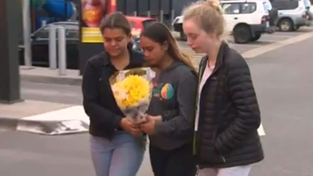 Friends of the boy lay flowers at the scene where he died