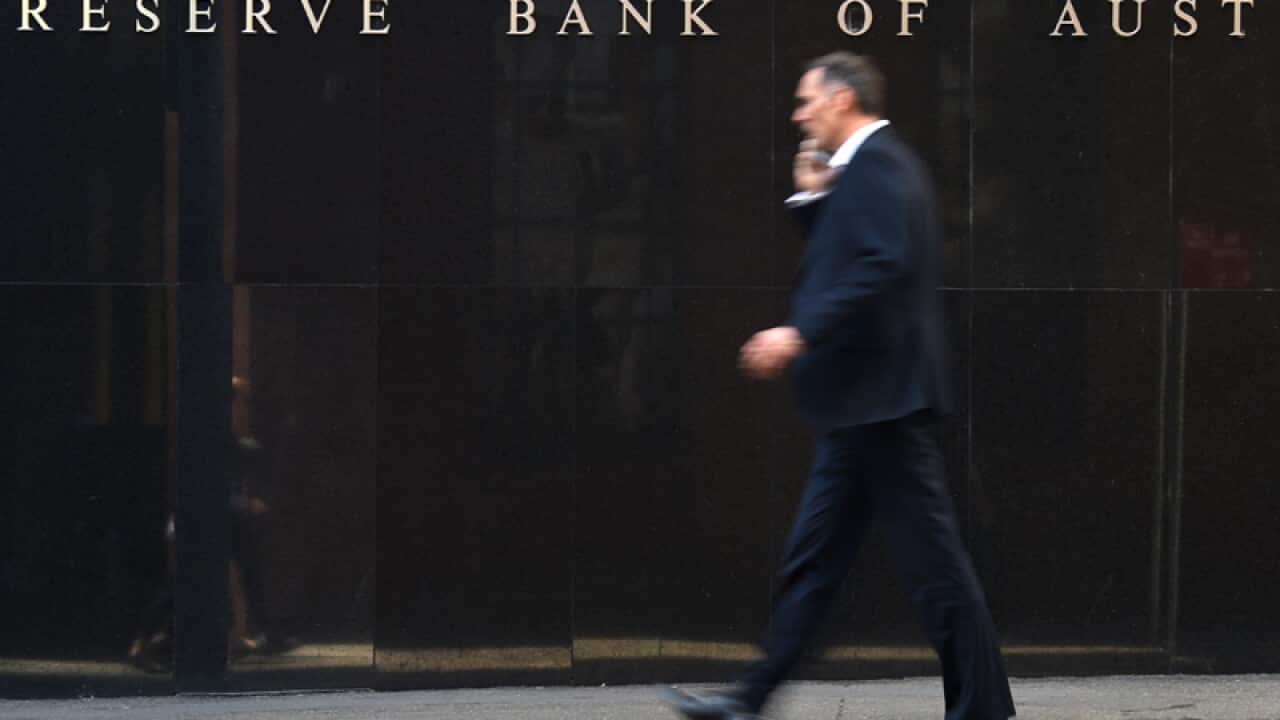 A pedestrian walks past the Reserve Bank of Australia (RBA)