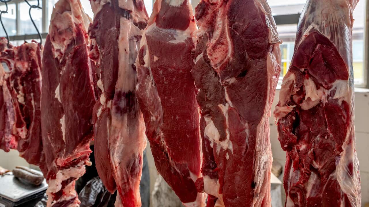 Raw beef hanging at marketplace in meat rawsss