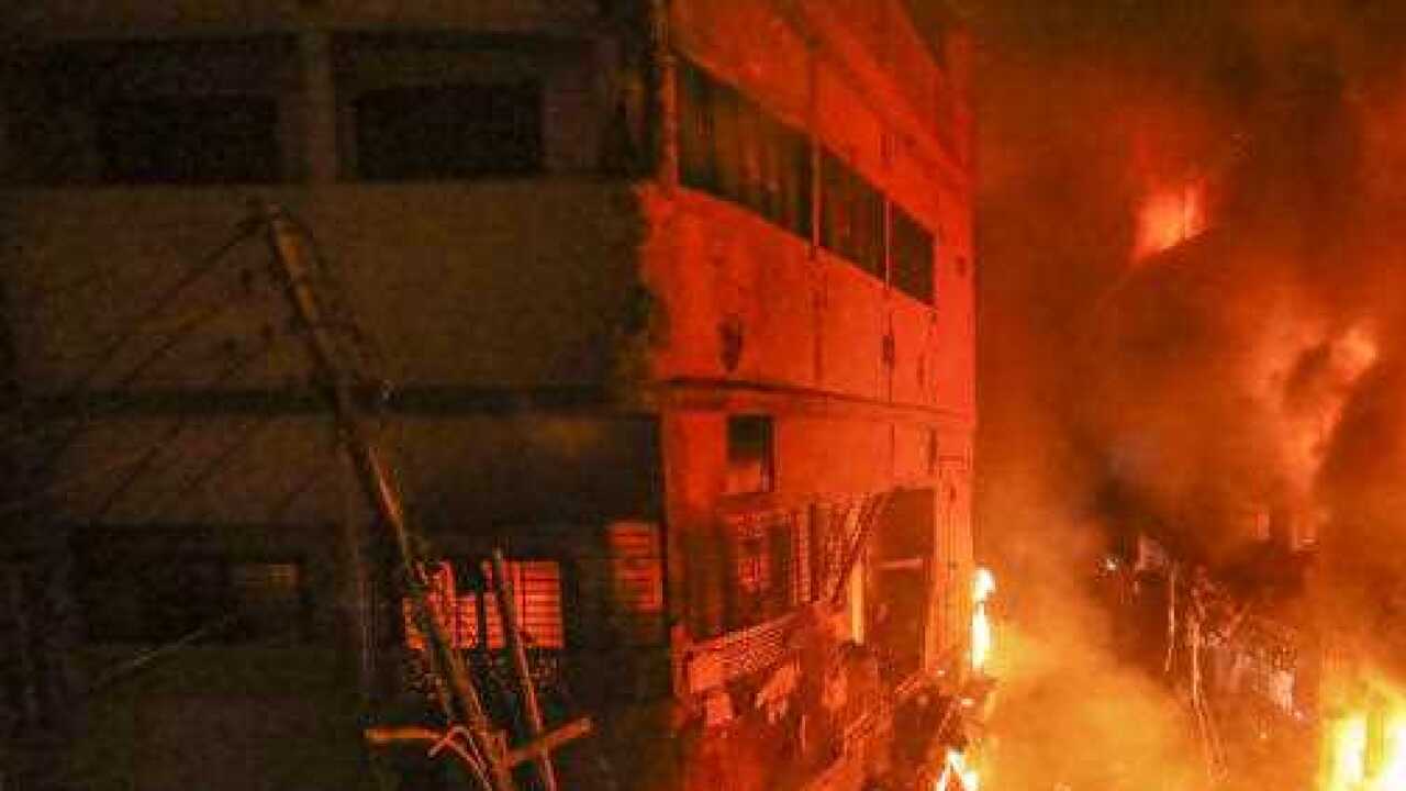 Flames rise from a fire in a densely packed shopping area in Dhaka, Bangladesh.