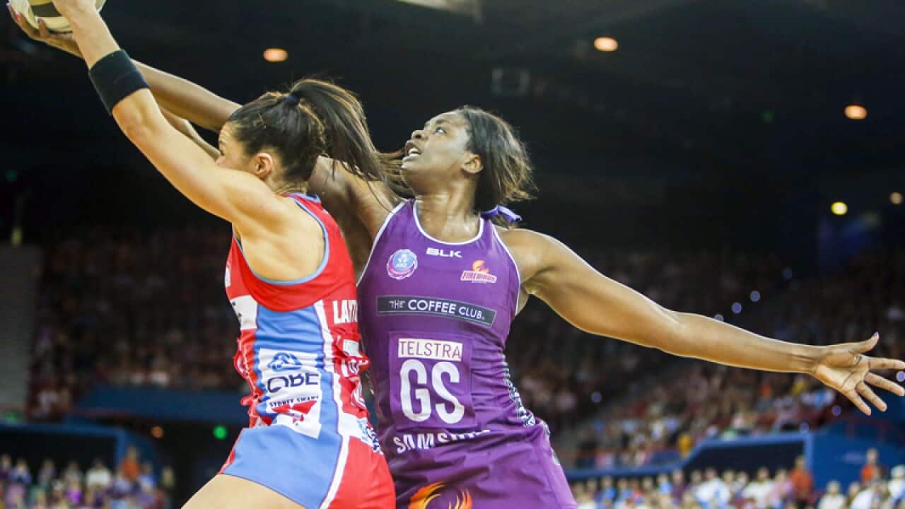 Romelda Aiken of the Firebirds contests the ball