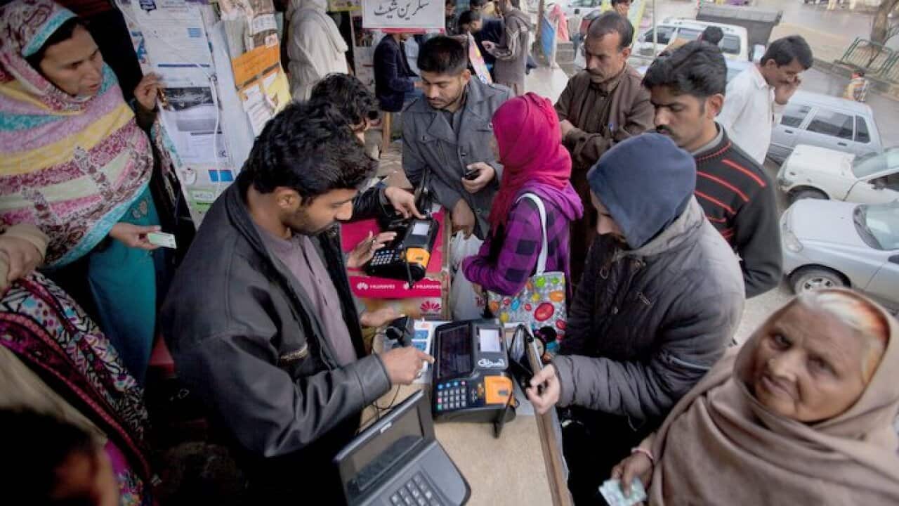 People lining up in Islamabad to give their fingerprints and to get their phone SIM cards registered