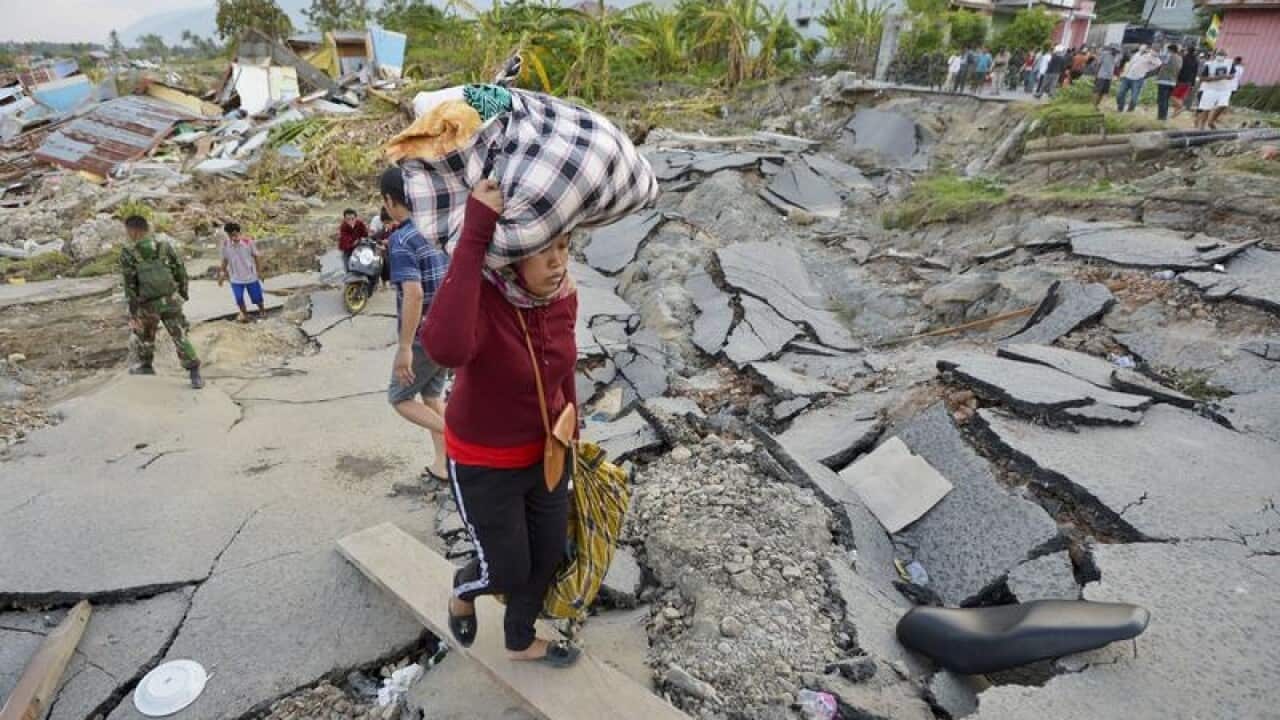 People bring out items from their village.
