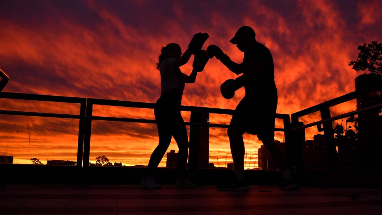 People working out as the sun sets over the Kangaroo Point Cliffs in Brisbane, Saturday, May 23, 2020.