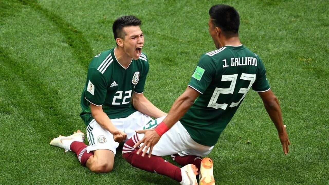 Hirving Lozano of Mexico celebrates with Jesus Gallardo by sliding on their knees after scoring his team's first goal