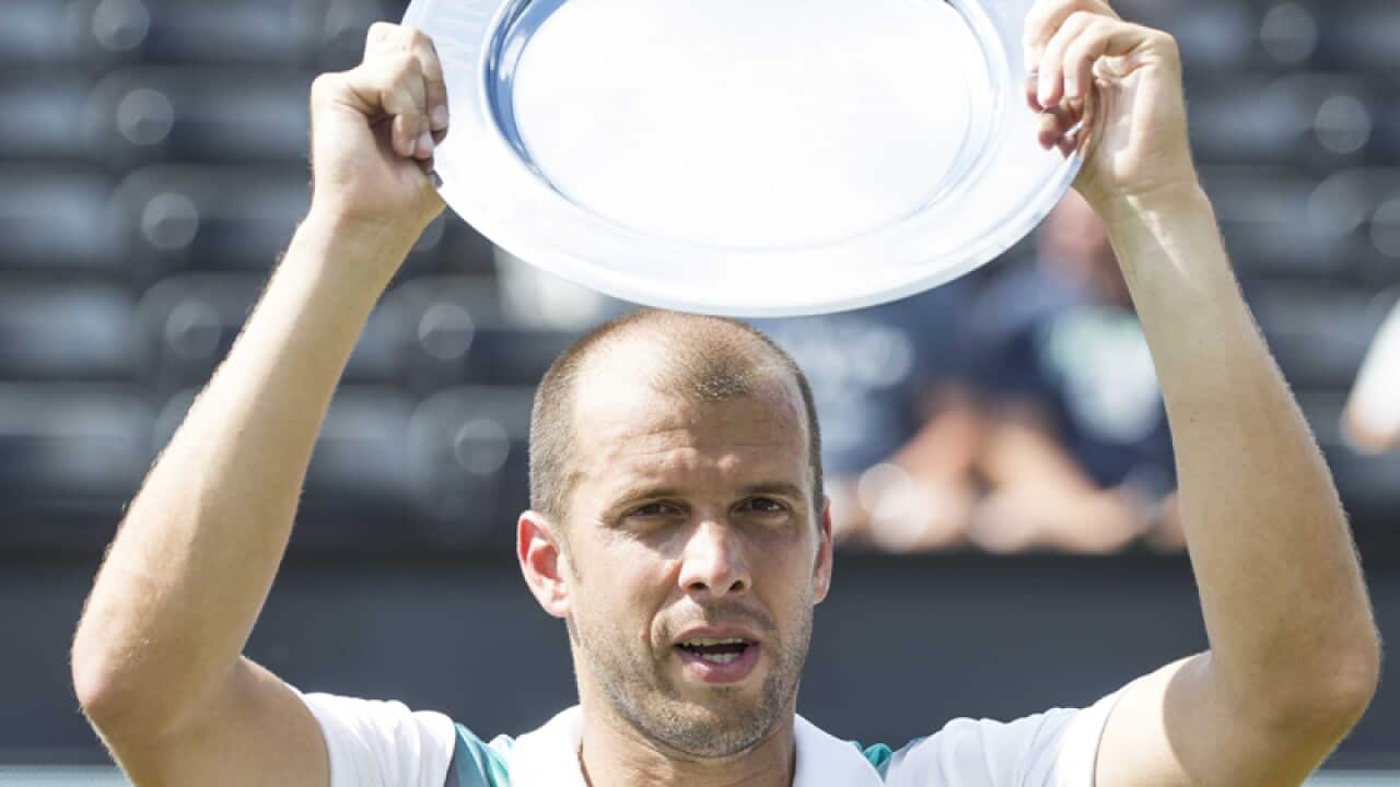Gilles Muller poses with his Ricoh Open Tennis trophy