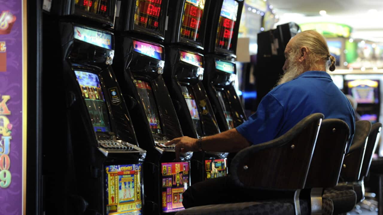A man playing a poker machine