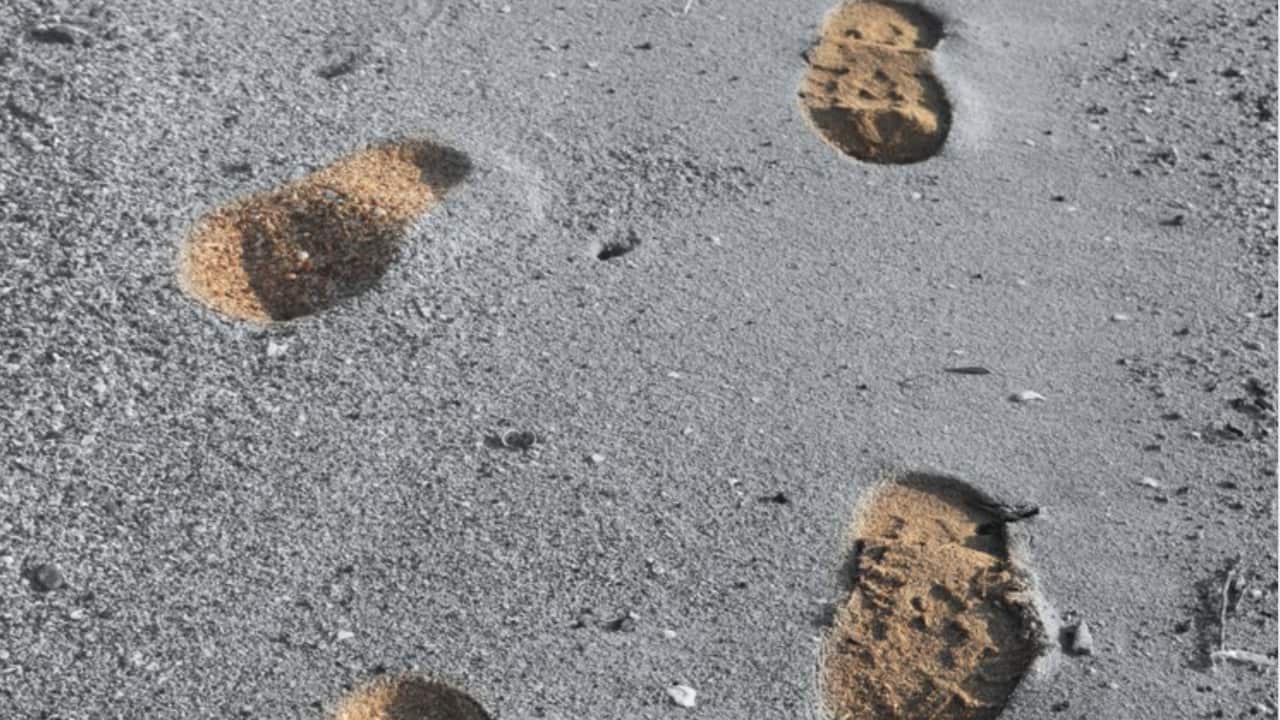 Footprints in the sand reconnecting identity.