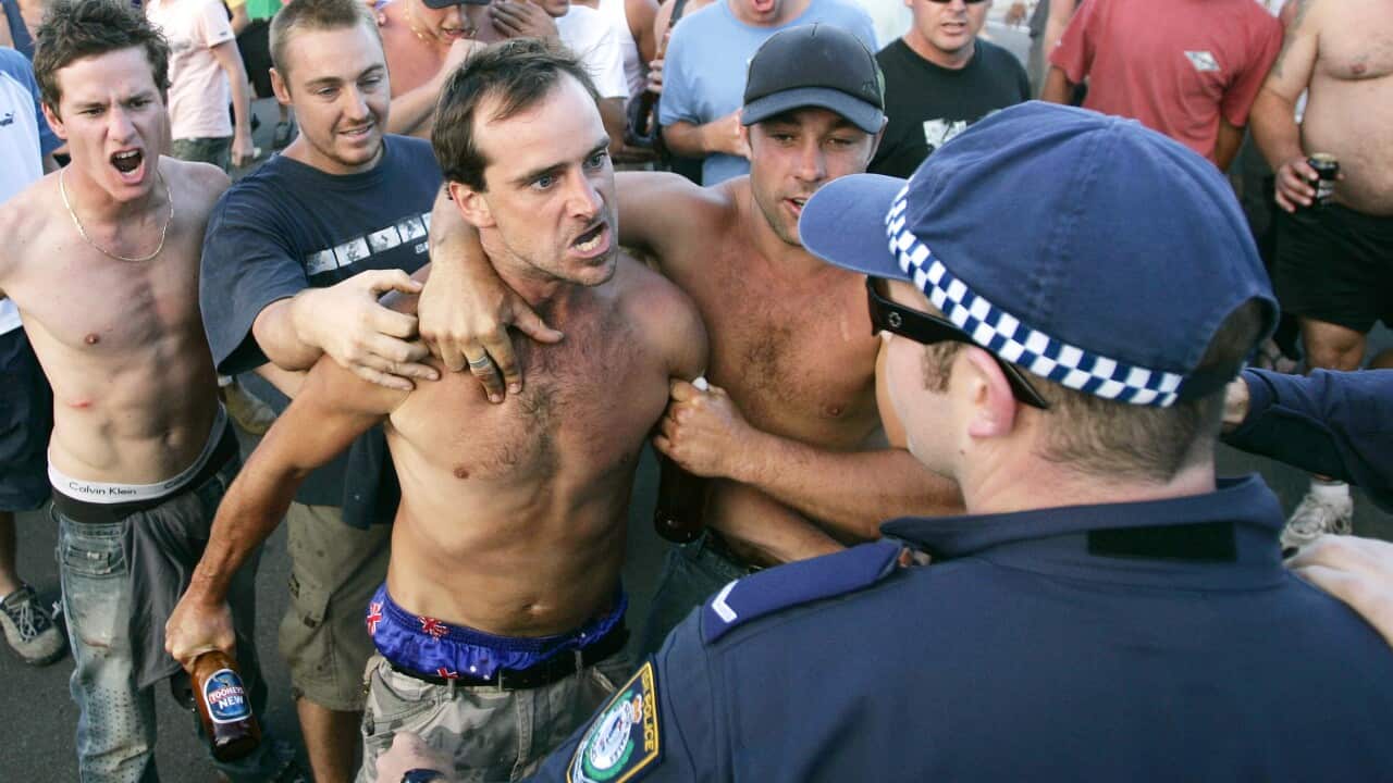 A man threatens police at Cronulla Beach during the riots.
