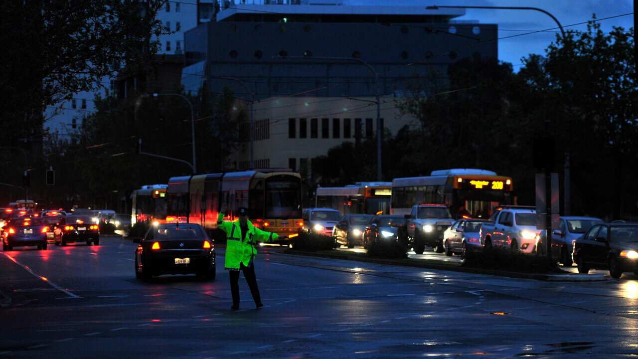 Police direct traffic around the CBD in Adelaide after the power network stops working. Wednesday September, 28, 2016.