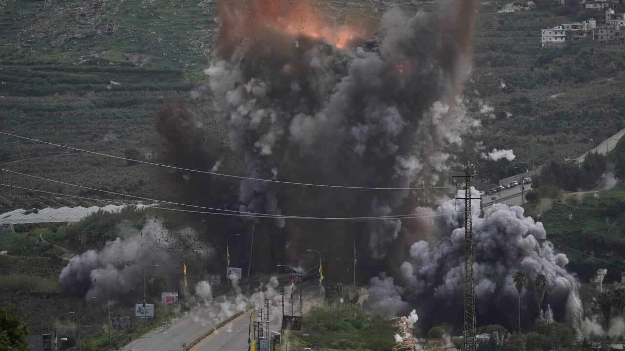 Smoke and flames rise from an Israeli airstrike that hit the Qasmiyeh Bridge near the coastal city of Tyre, Lebanon, Sunday, March 22, 2026.