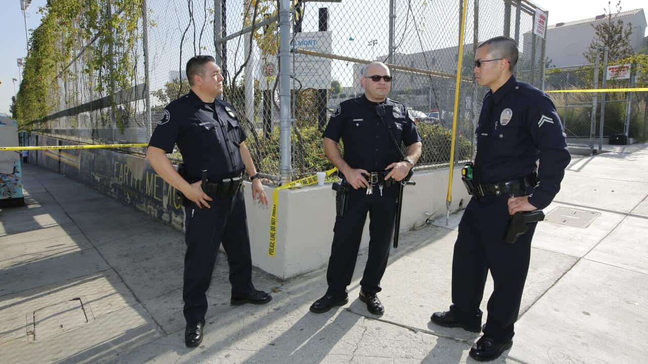 Los Angeles School Police officers stand on guard outside the campus of the Salvador B. Castro Middle School near downtown Los Angeles.