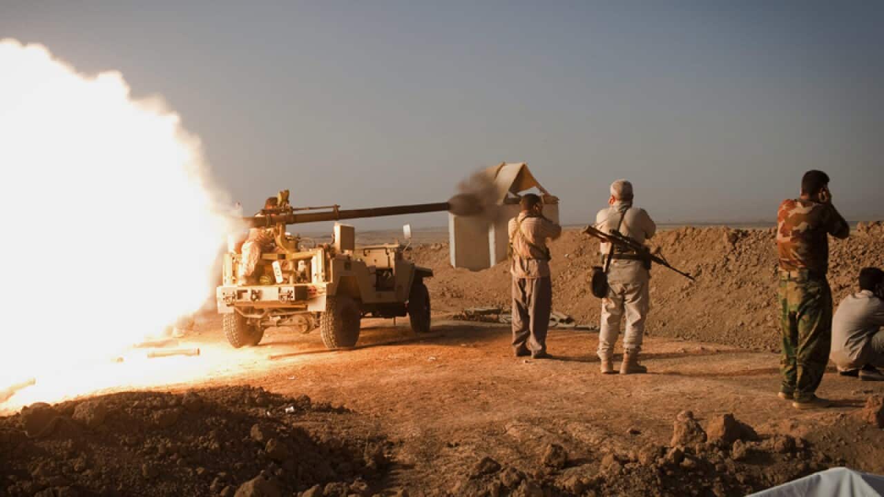 Peshmerga fighters fire cannon towards Islamic State positions in Iraq