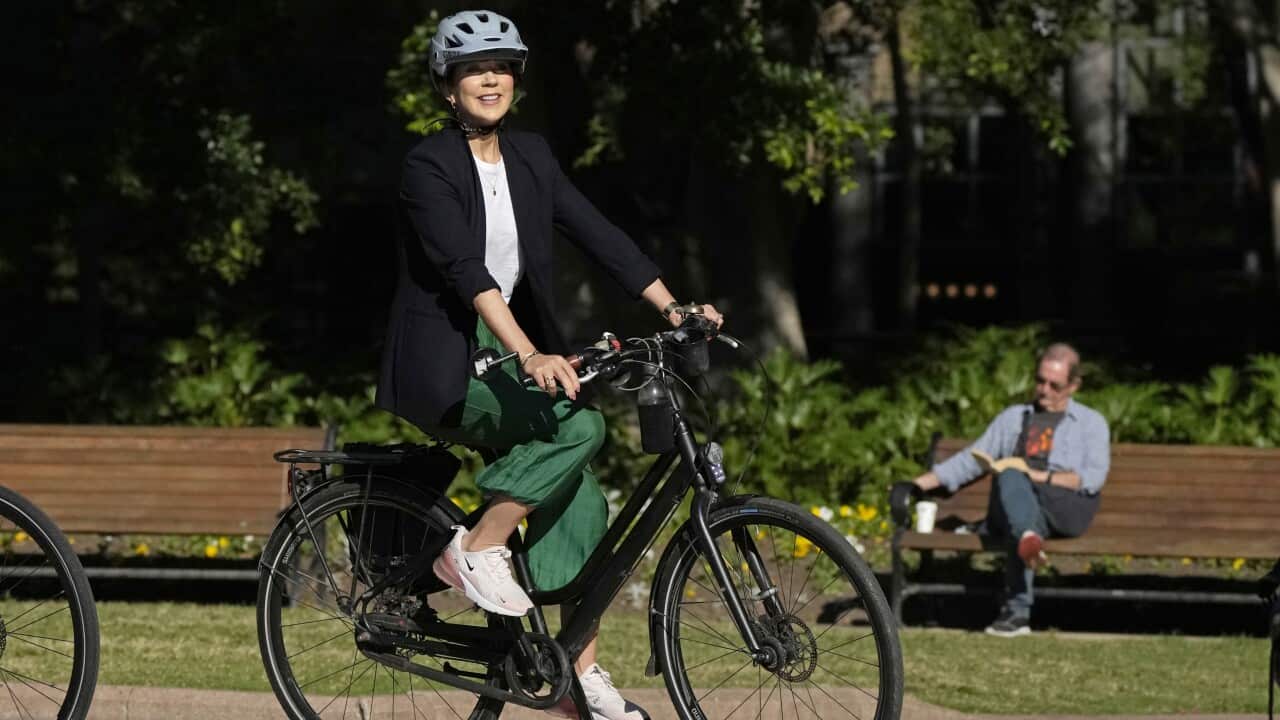 Denmark's Crown Princess Mary rides a bike.
