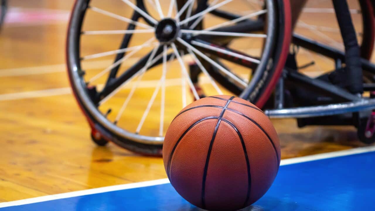 Close up basketball next to professional customized sports wheelchair
