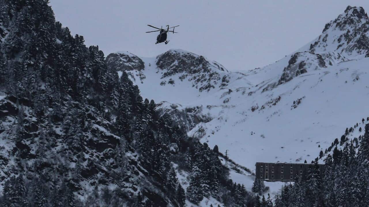 An helicopter flies to the site of an avalanche near Valfrejus, France, 18 January 2016.