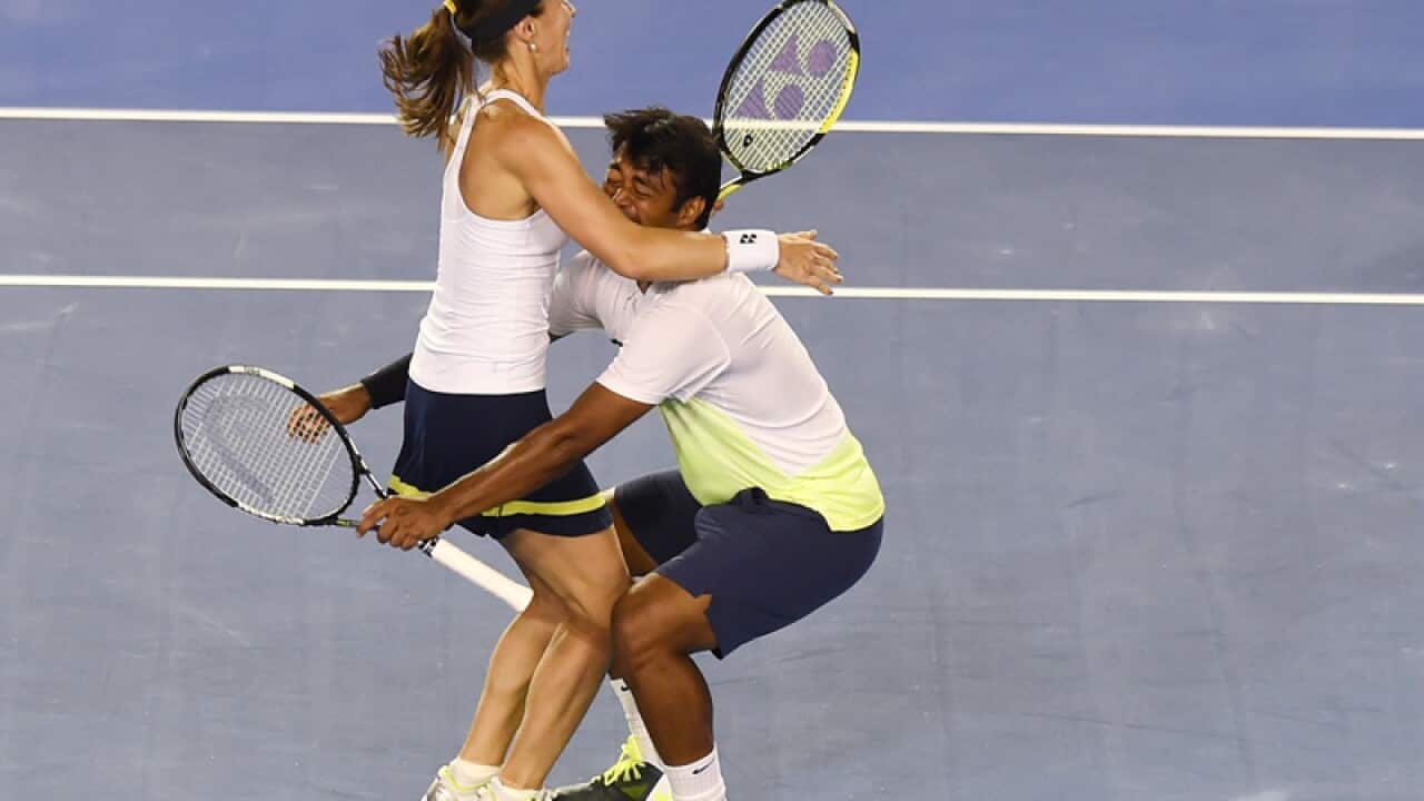 Martina Hingis (L) of Switzerland and Leander Paes of India celebrate