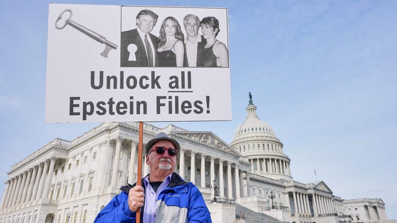 Gary Rush, College Park, MD, holds a sign before a news conference on the Epstein files in front of the Capitol, Tuesday, Nov. 18, 2025, in Washington.