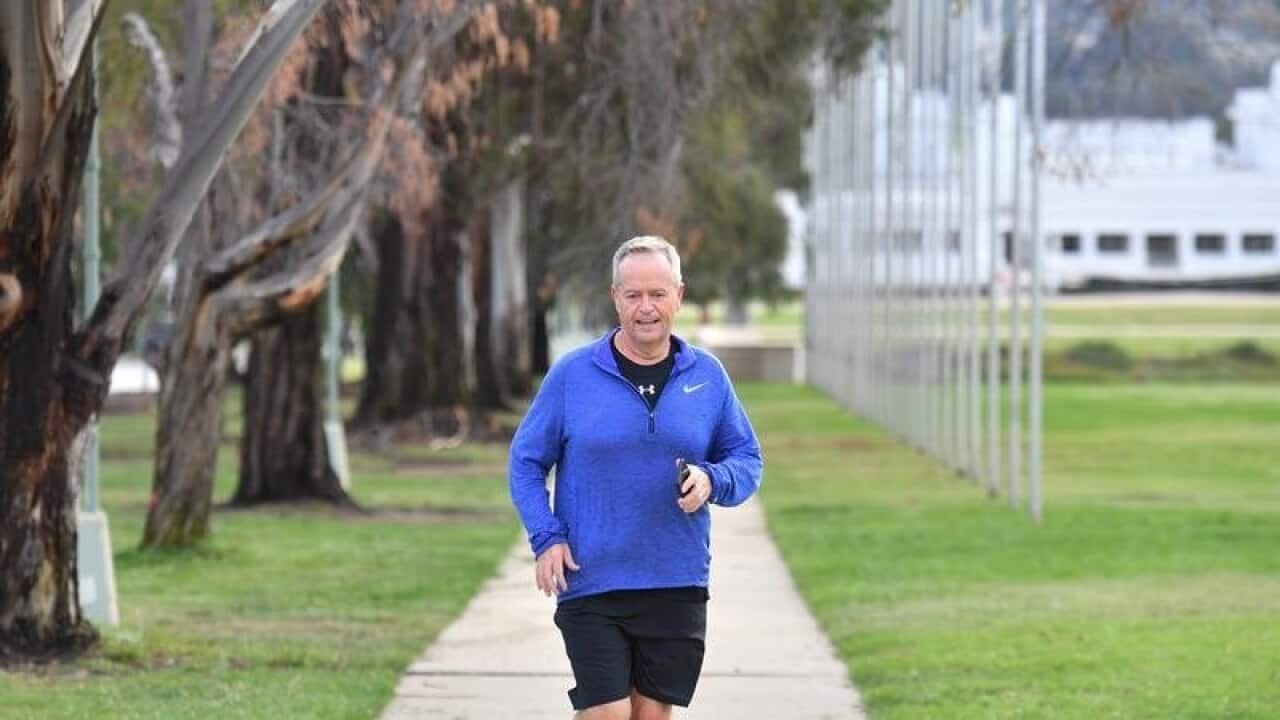 Opposition Leader Bill Shorten jogs to Parliament House.
