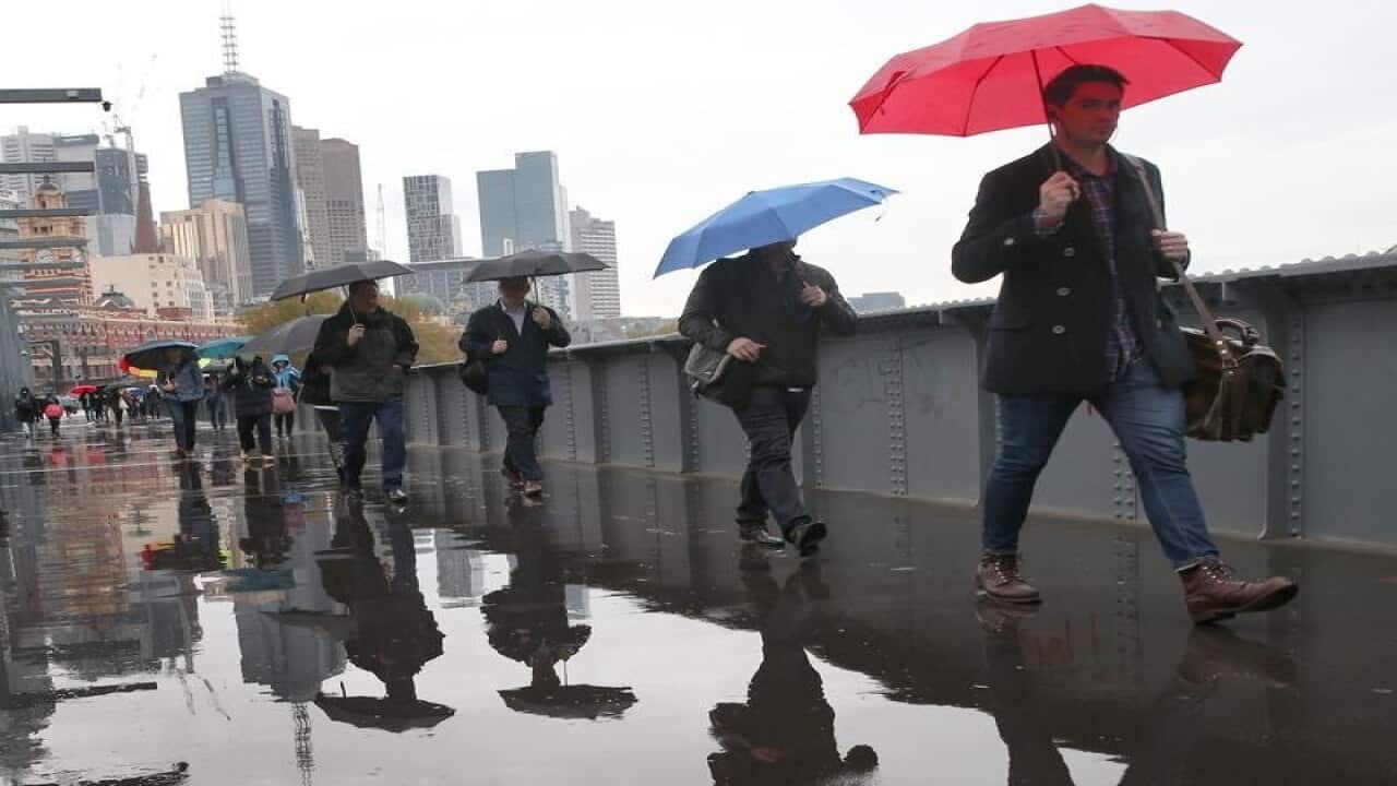 Pedestrians with umbrellas in Melbourne.