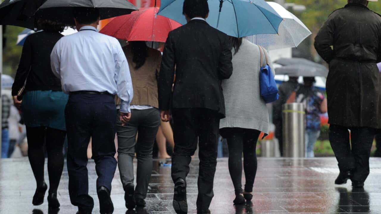Pedestrians walk in Sydney